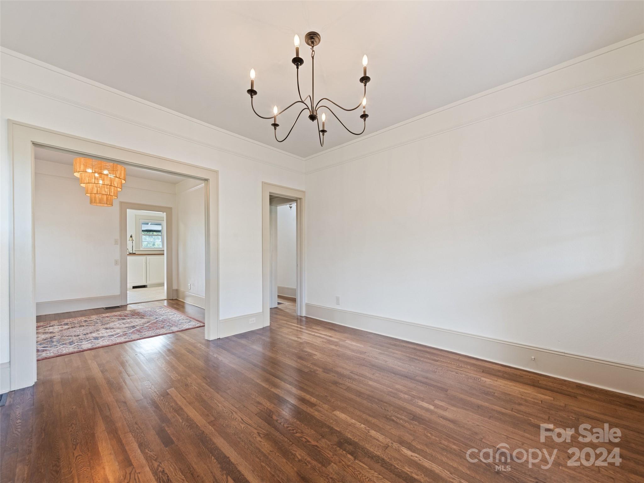 15 Scottdale Road Canton, NC 28716 - Photo 8 of 30 a view of an empty room with wooden floor and windows
