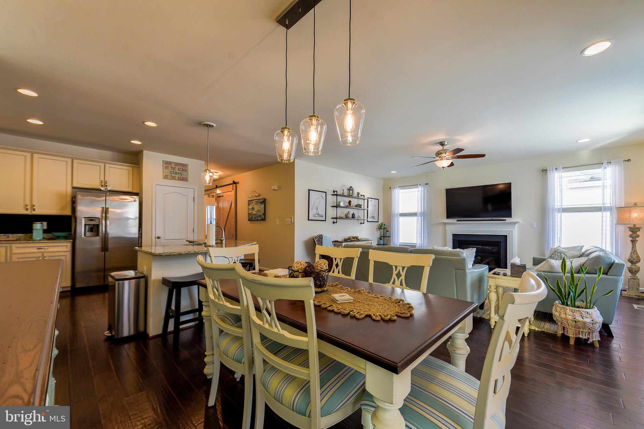 34148 Spring Brook Avenue Lewes, DE 19958 - Photo 12 of 77 a view of a dining room with furniture wooden floor and chandelier