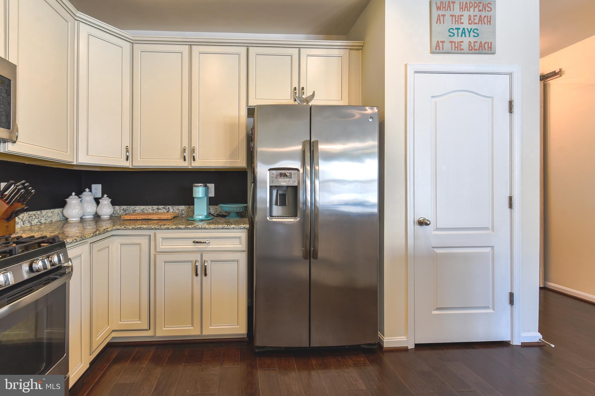 34148 Spring Brook Avenue Lewes, DE 19958 - Photo 17 of 77 a kitchen with stainless steel appliances granite countertop a refrigerator and a stove