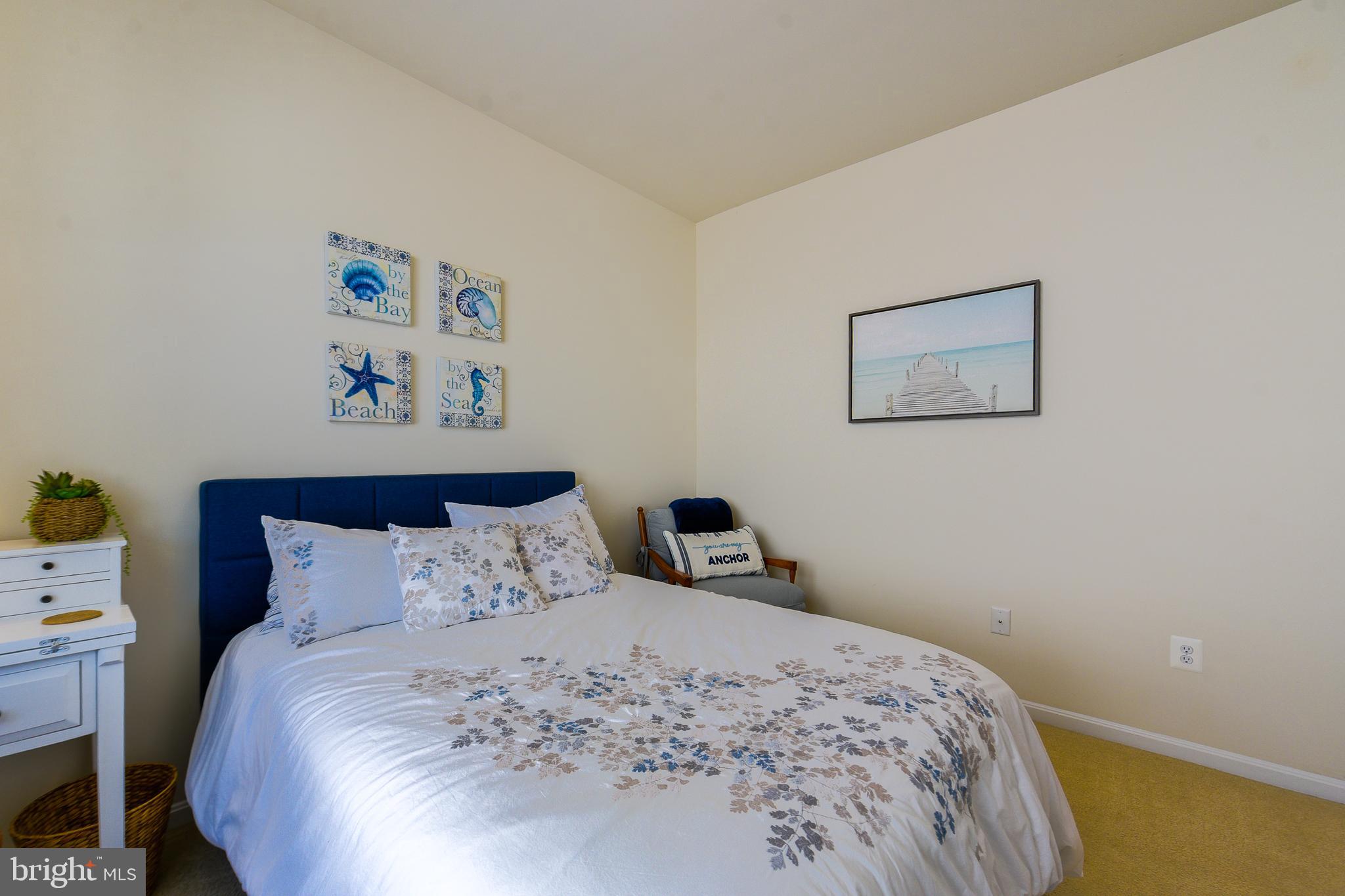 34148 Spring Brook Avenue Lewes, DE 19958 - Photo 29 of 77 a bedroom with a bed and painting on the wall