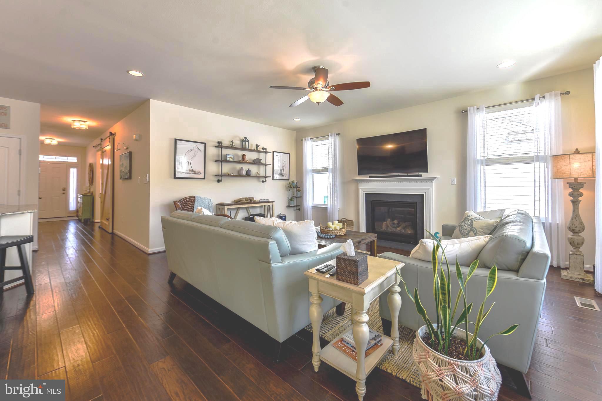 34148 Spring Brook Avenue Lewes, DE 19958 - Photo 6 of 77 a living room with furniture fireplace and flat screen tv