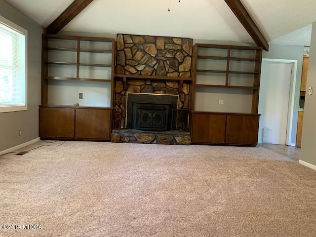 8449 Lower Thomaston Road Lizella, GA 31052 - Photo 4 of 9 a living room with a fireplace and a window