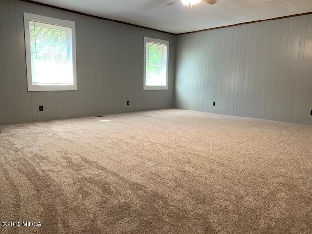 8449 Lower Thomaston Road Lizella, GA 31052 - Photo 5 of 9 a view of an empty room with a window