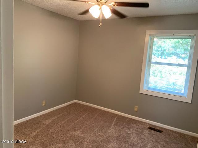 8449 Lower Thomaston Road Lizella, GA 31052 - Photo 6 of 9 an empty room with a window