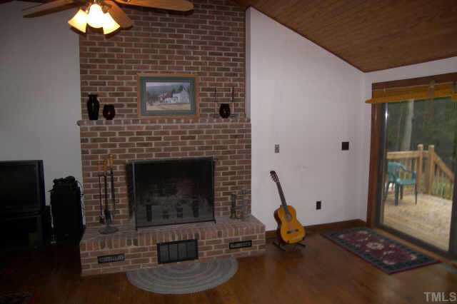 8212 Ridgeback Road Apex, NC 27523 - Photo 6 of 10 a living room with a fireplace and a chandelier