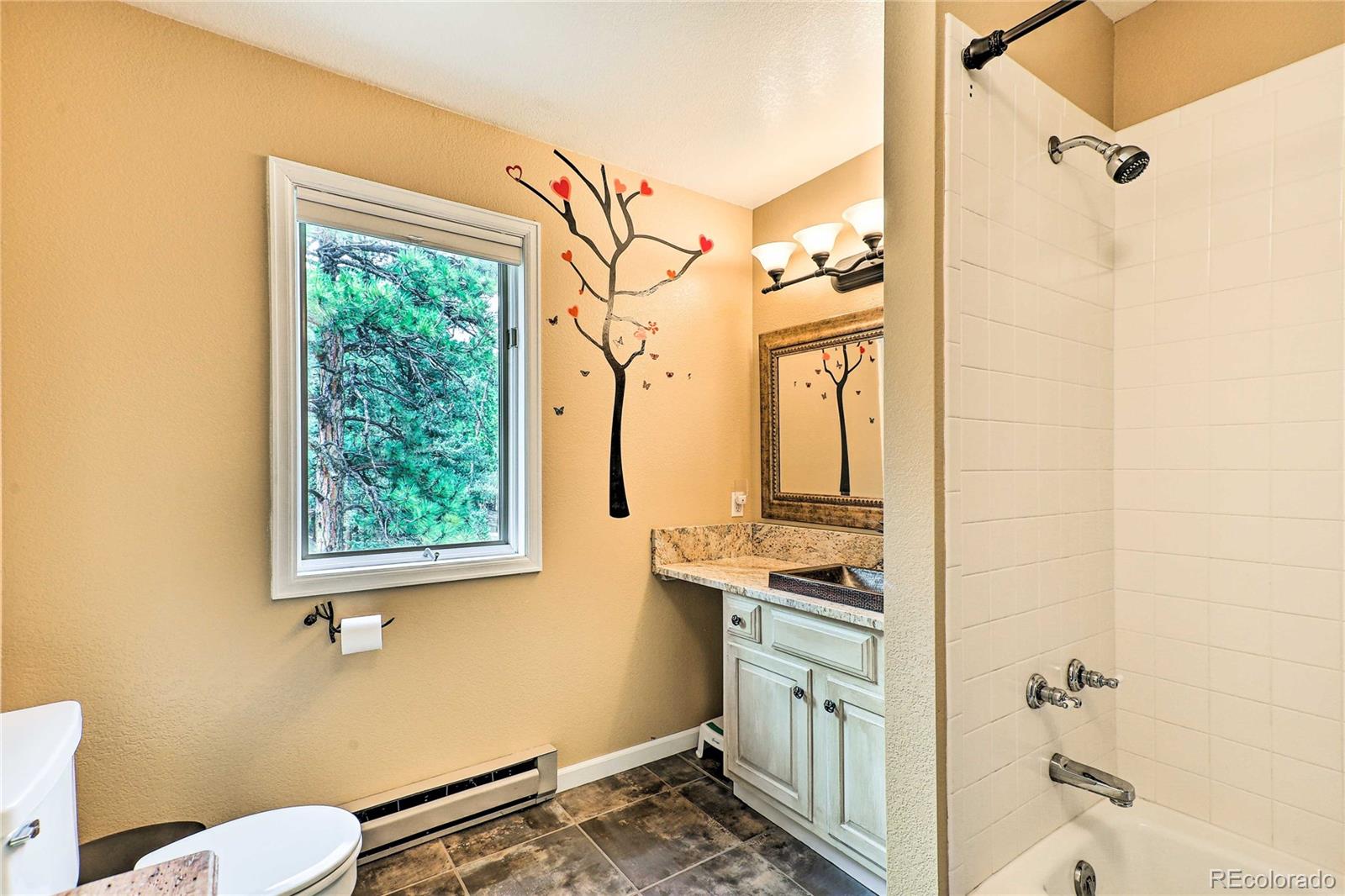 345 Old Sawmill Road Bailey, CO 80421 - Photo 21 of 39 a bathroom with a sink a toilet and shower