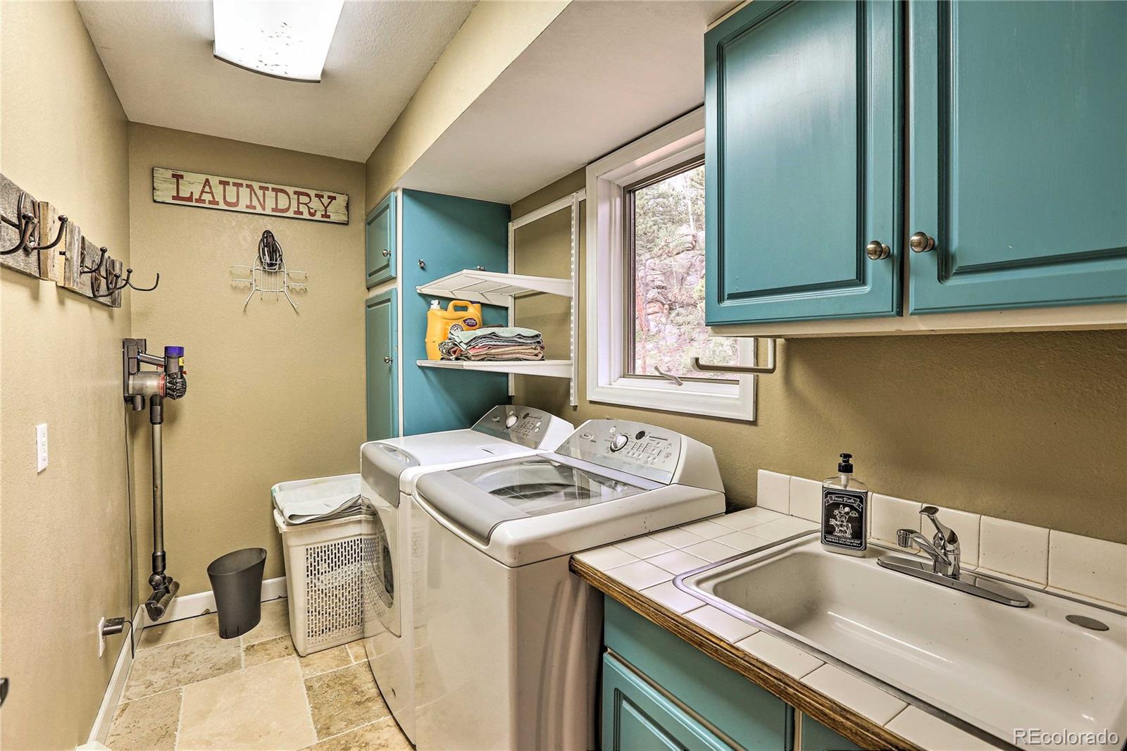 345 Old Sawmill Road Bailey, CO 80421 - Photo 29 of 39 a utility room with sink dryer and washer