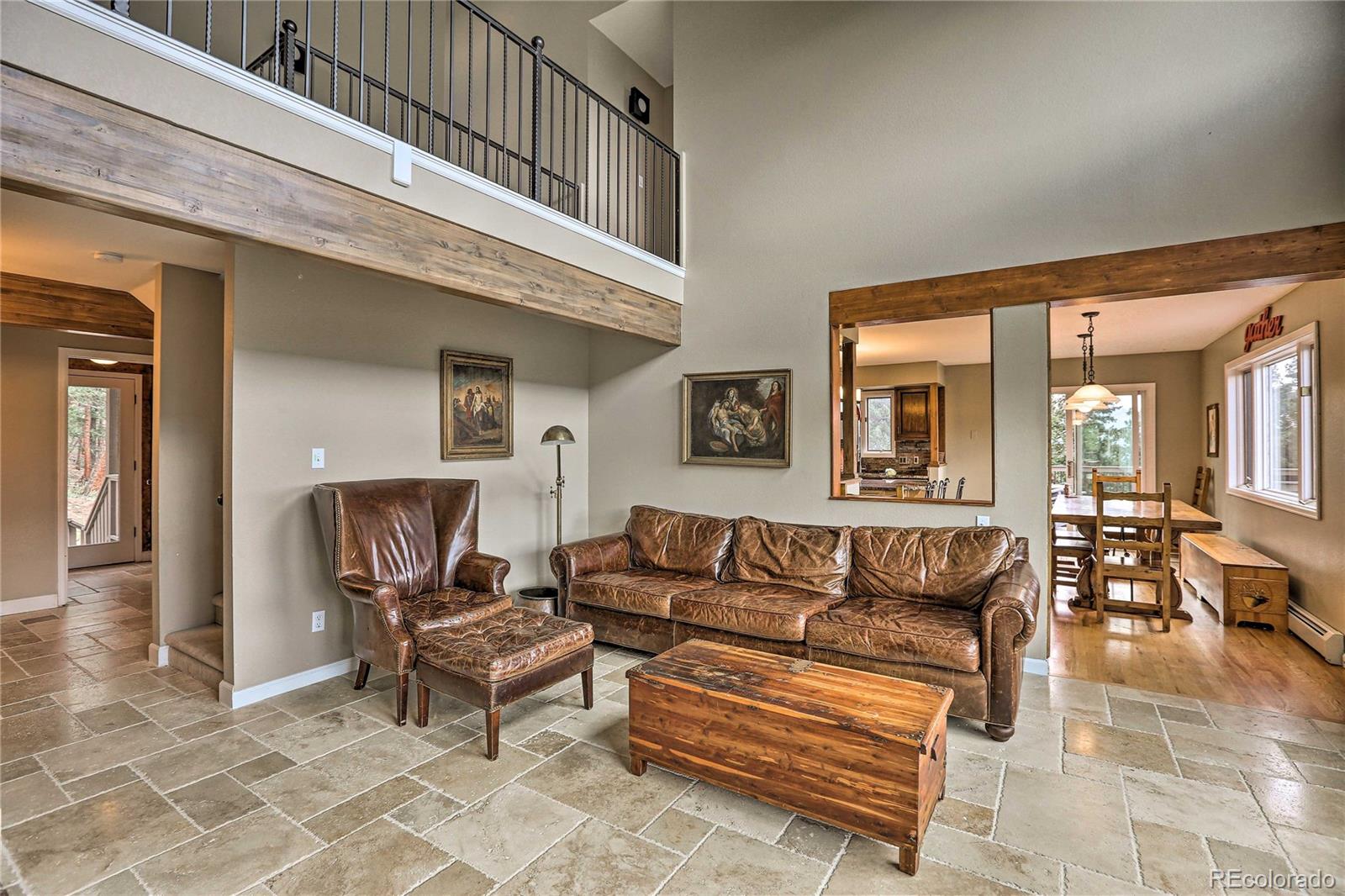 345 Old Sawmill Road Bailey, CO 80421 - Photo 4 of 39 a living room with furniture and a potted plant