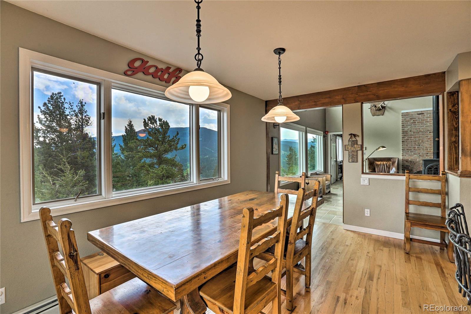 345 Old Sawmill Road Bailey, CO 80421 - Photo 10 of 39 a view of a dining room with furniture window and outside view