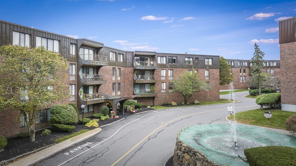 1002 Paradise Road, Unit PHE Swampscott, MA 01907 - Photo 2 of 23 a front view of a building with a garden and plants