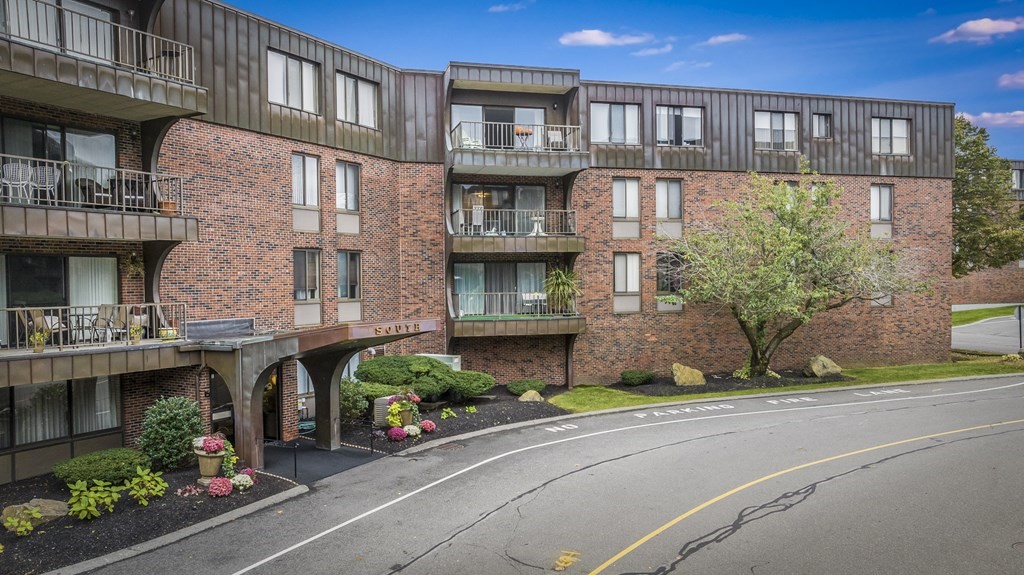 1002 Paradise Road, Unit PHE Swampscott, MA 01907 - Photo 3 of 23 a front view of a building with garden