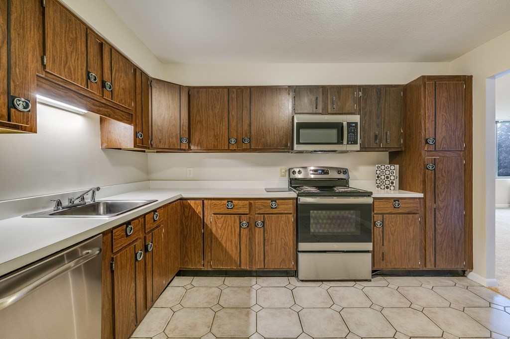 1002 Paradise Road, Unit PHE Swampscott, MA 01907 - Photo 10 of 23 a kitchen with stainless steel appliances granite countertop a stove a sink and a microwave