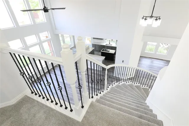 a view of staircase with railing and white walls
