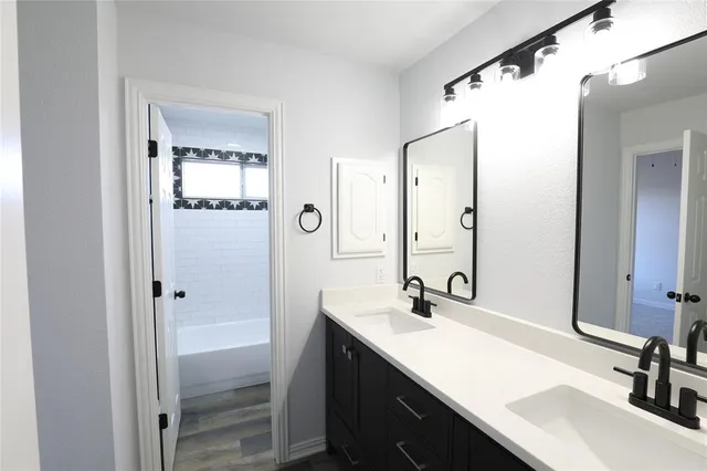 a bathroom with a double vanity sink a and mirror