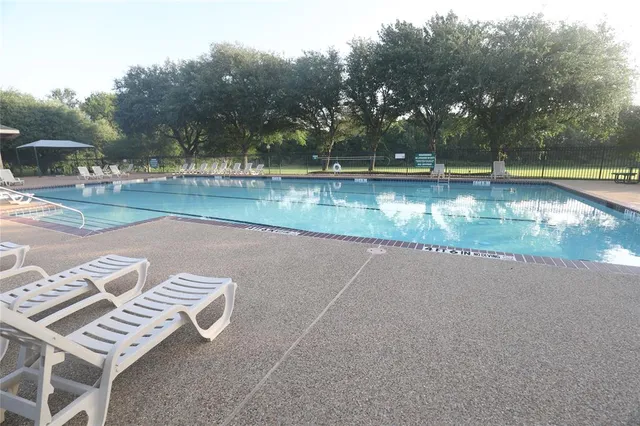 an aerial view of residential houses with outdoor space and river