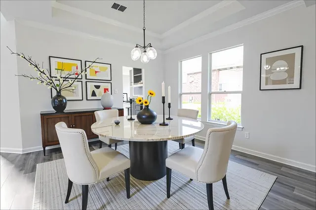 a view of a dining room with furniture wooden floor and chandelier