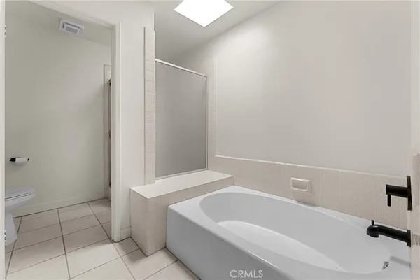 a white toilet sitting next to a bathroom sink