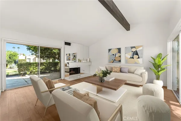 a living room with furniture fireplace and a large window