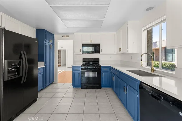 a kitchen with a refrigerator sink and stove