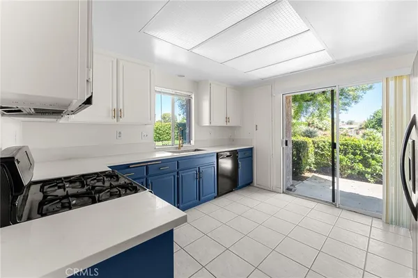 a kitchen with a sink a stove a refrigerator and cabinets