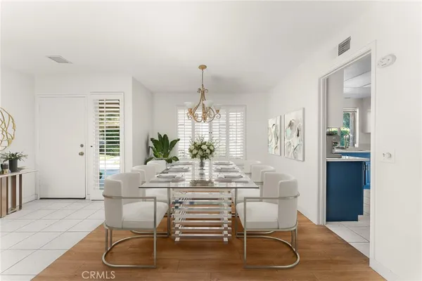 a dining room with furniture window and wooden floor