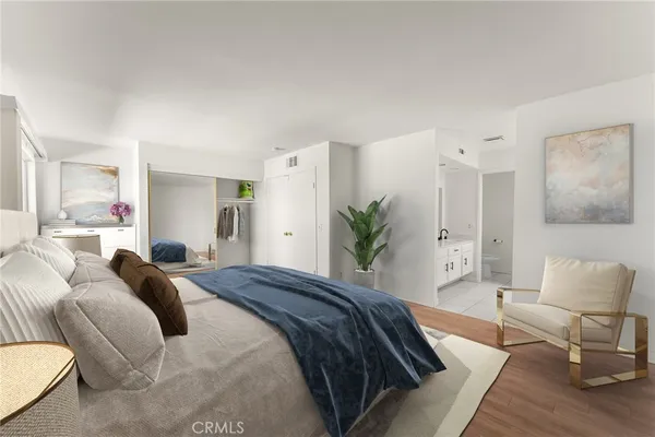 a bedroom with a bed and a couch