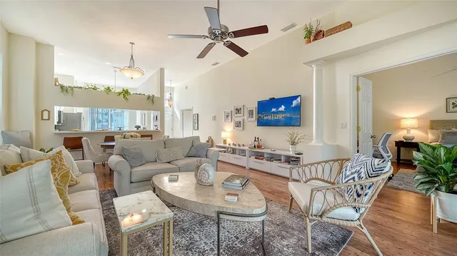 a living room with furniture a ceiling fan and a window