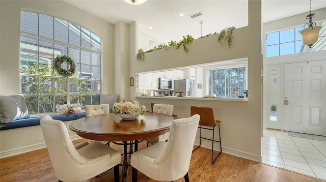 a dining room with furniture and wooden floor