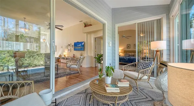 a living room with furniture and a floor to ceiling window