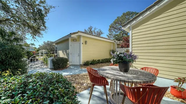 a view of a house with backyard and sitting area