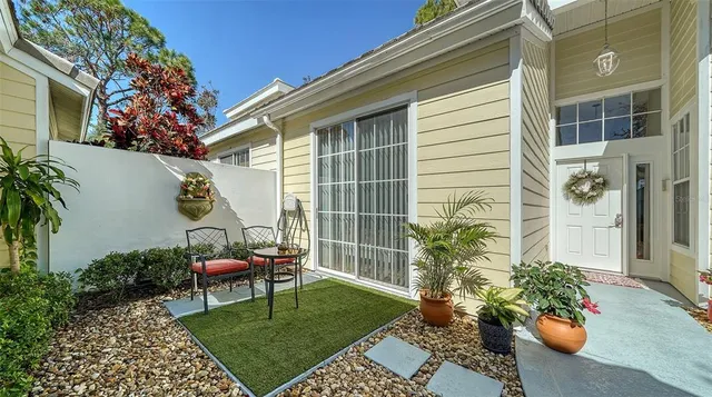 a view of a chair and table in backyard of the house