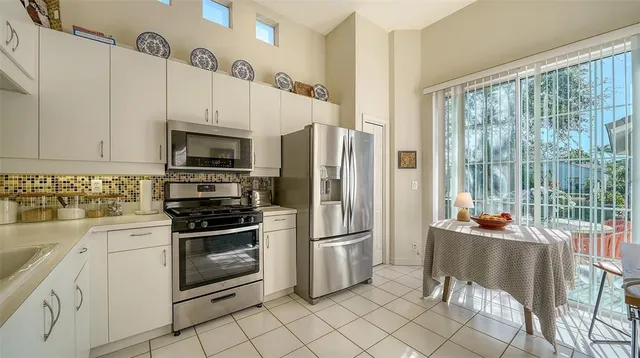 a kitchen with stainless steel appliances a stove a sink and a refrigerator