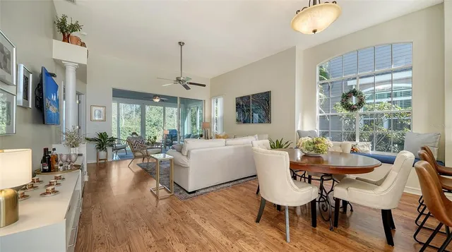 a living room with furniture dining table and a large window