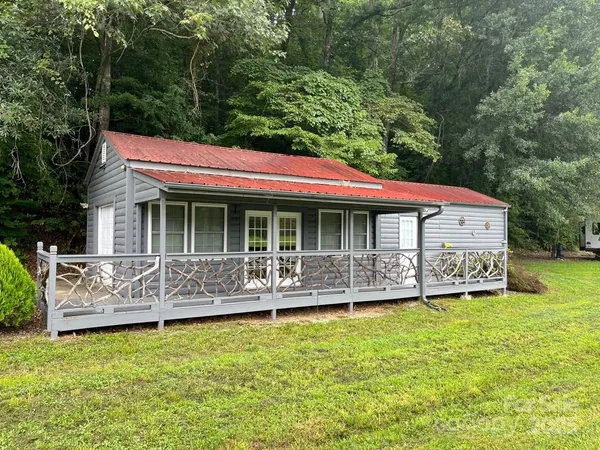 a front view of house with outdoor seating yard and green space