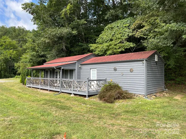 a backyard of a house with a garden and deck