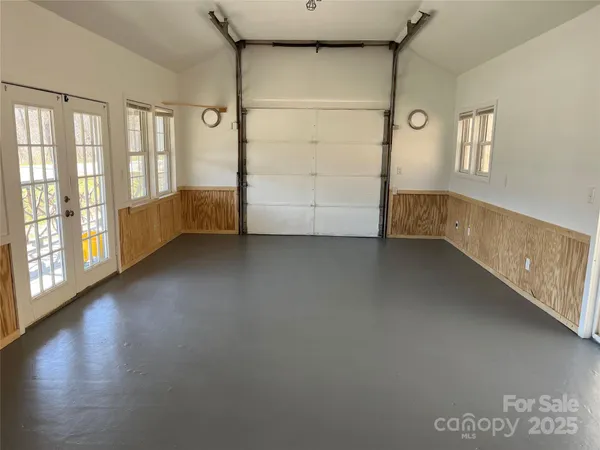 a kitchen with white cabinets and appliances