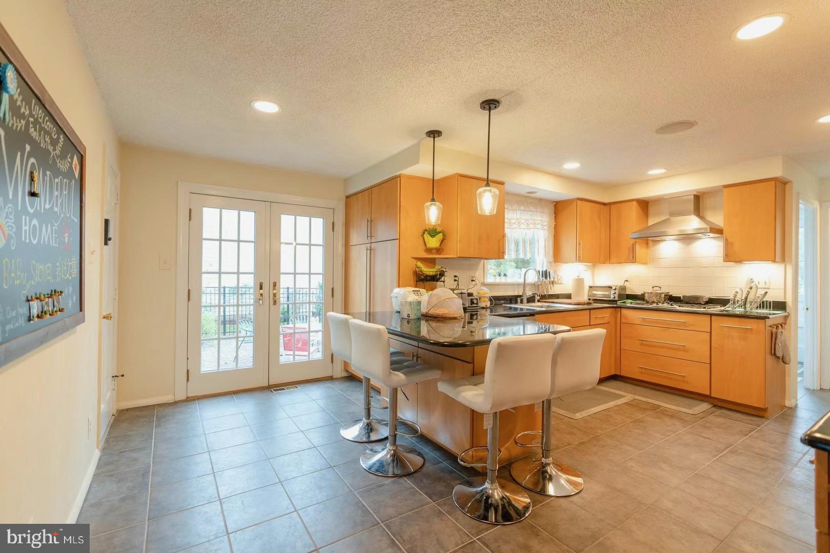 8 Ramsgate Road Cherry Hill, NJ 08003 - Photo 11 of 42 a view of a kitchen with kitchen island granite countertop a stove a sink a dining table and chair
