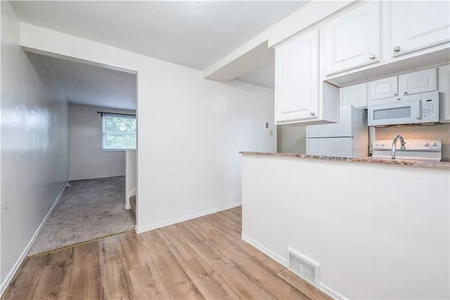 a view of a kitchen and utility room