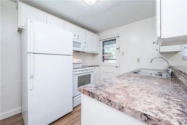 a kitchen with a stove a refrigerator and a sink