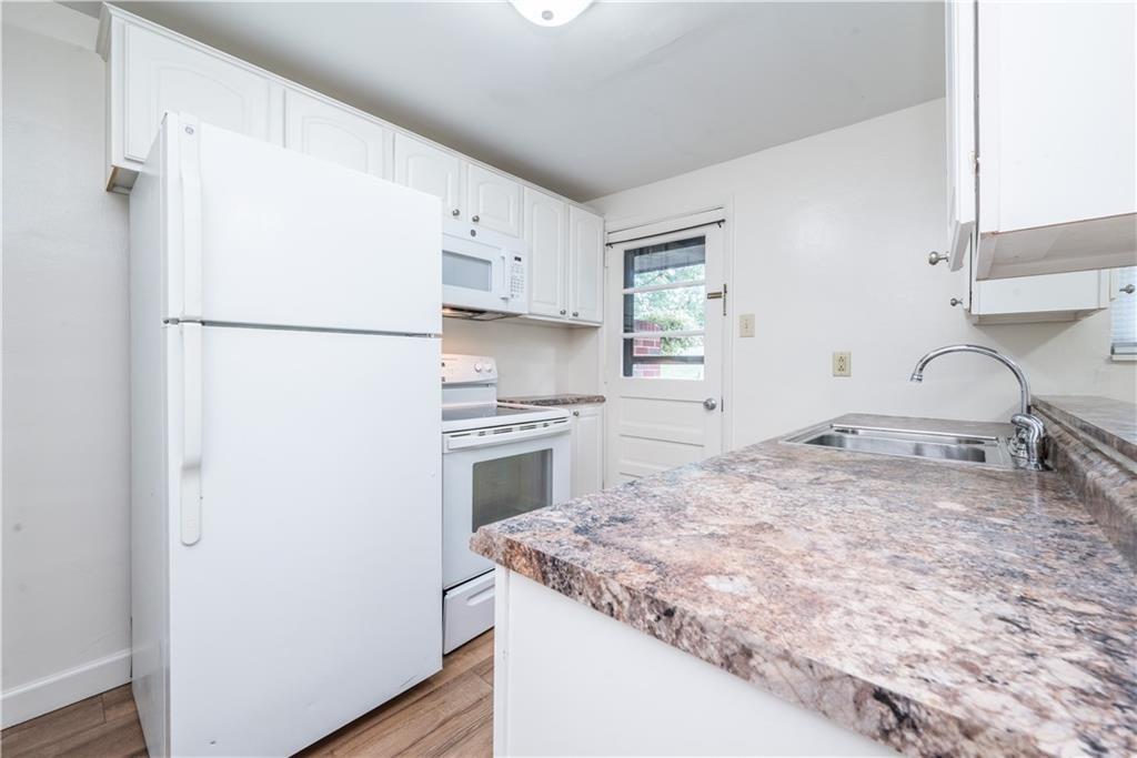 334 Moon Clinton Road, Unit B Coraopolis, PA 15108 - Photo 13 of 46 a kitchen with a stove a refrigerator and a sink