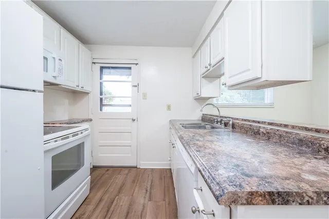 a kitchen with a stove oven and sink