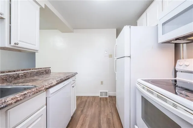a view of a kitchen with a sink and dishwasher