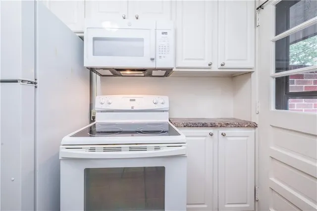 a stove top oven sitting inside of a kitchen