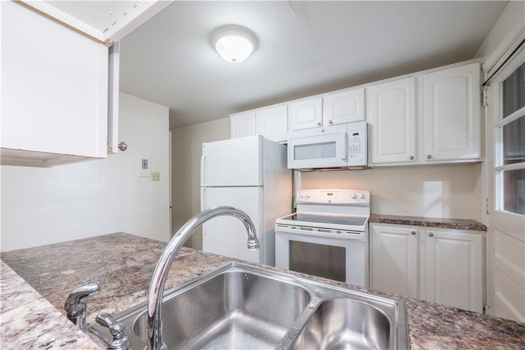 334 Moon Clinton Road, Unit B Coraopolis, PA 15108 - Photo 21 of 46 a kitchen with white cabinets and a refrigerator