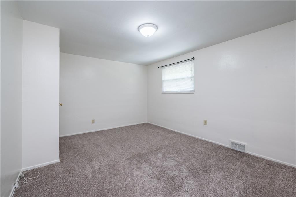 334 Moon Clinton Road, Unit B Coraopolis, PA 15108 - Photo 26 of 46 an empty room with a fan and windows