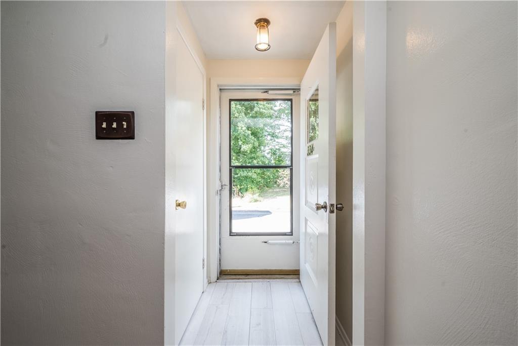 334 Moon Clinton Road, Unit B Coraopolis, PA 15108 - Photo 4 of 46 a view of a hallway with wooden floor and a bathroom