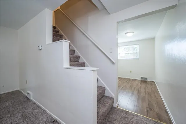 a view of a hallway with stairs