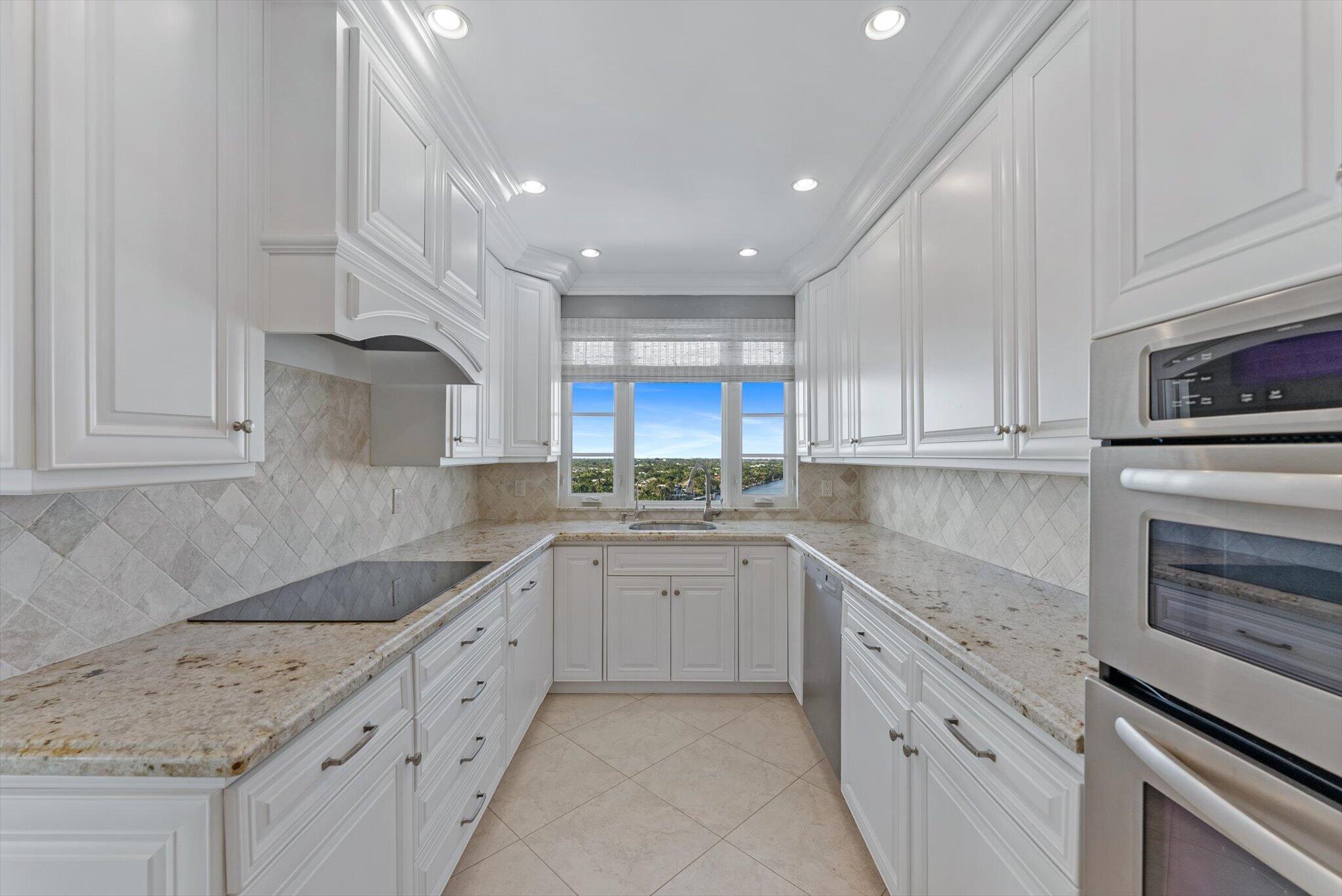 50 E Road, Unit 12A Delray Beach, FL 33483 - Photo 19 of 47 a kitchen that has a sink and a stove in it