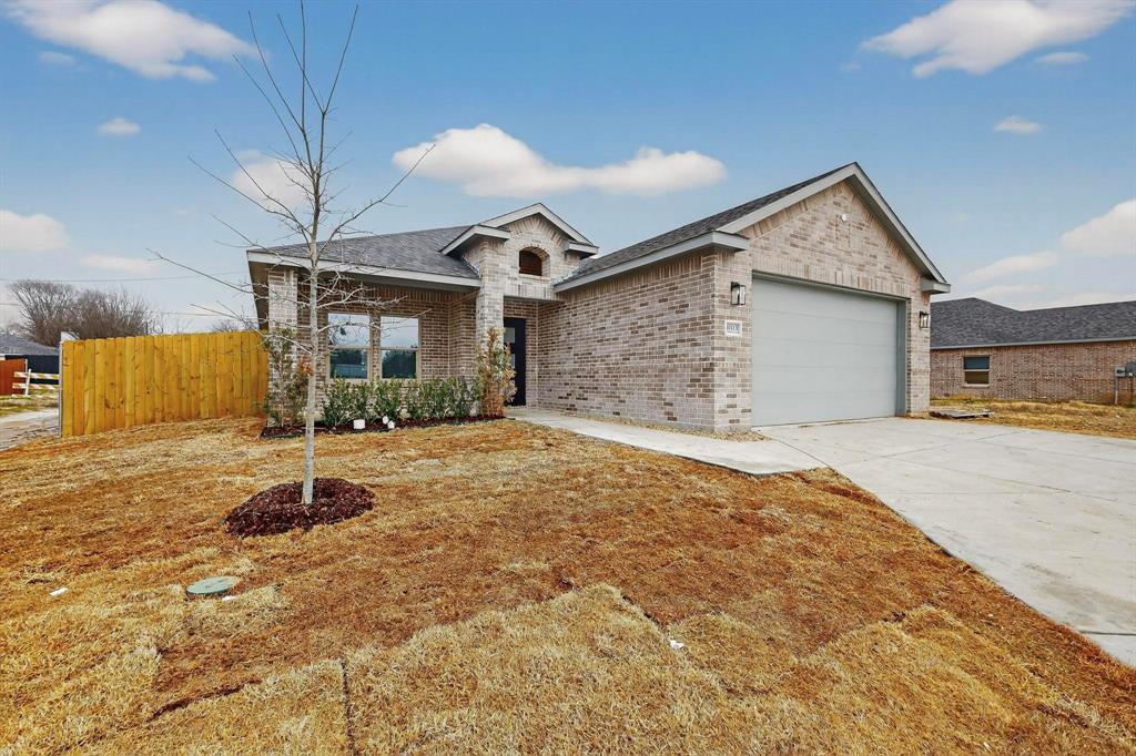 10166 Budtime Lane Dallas, TX 75217 - Photo 3 of 34 a backyard of a house with yard and retail shops