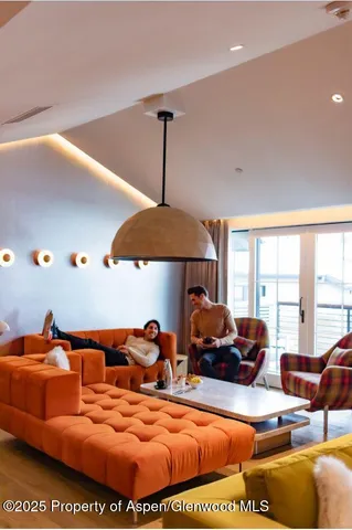 a living room with furniture a couch and a chandelier